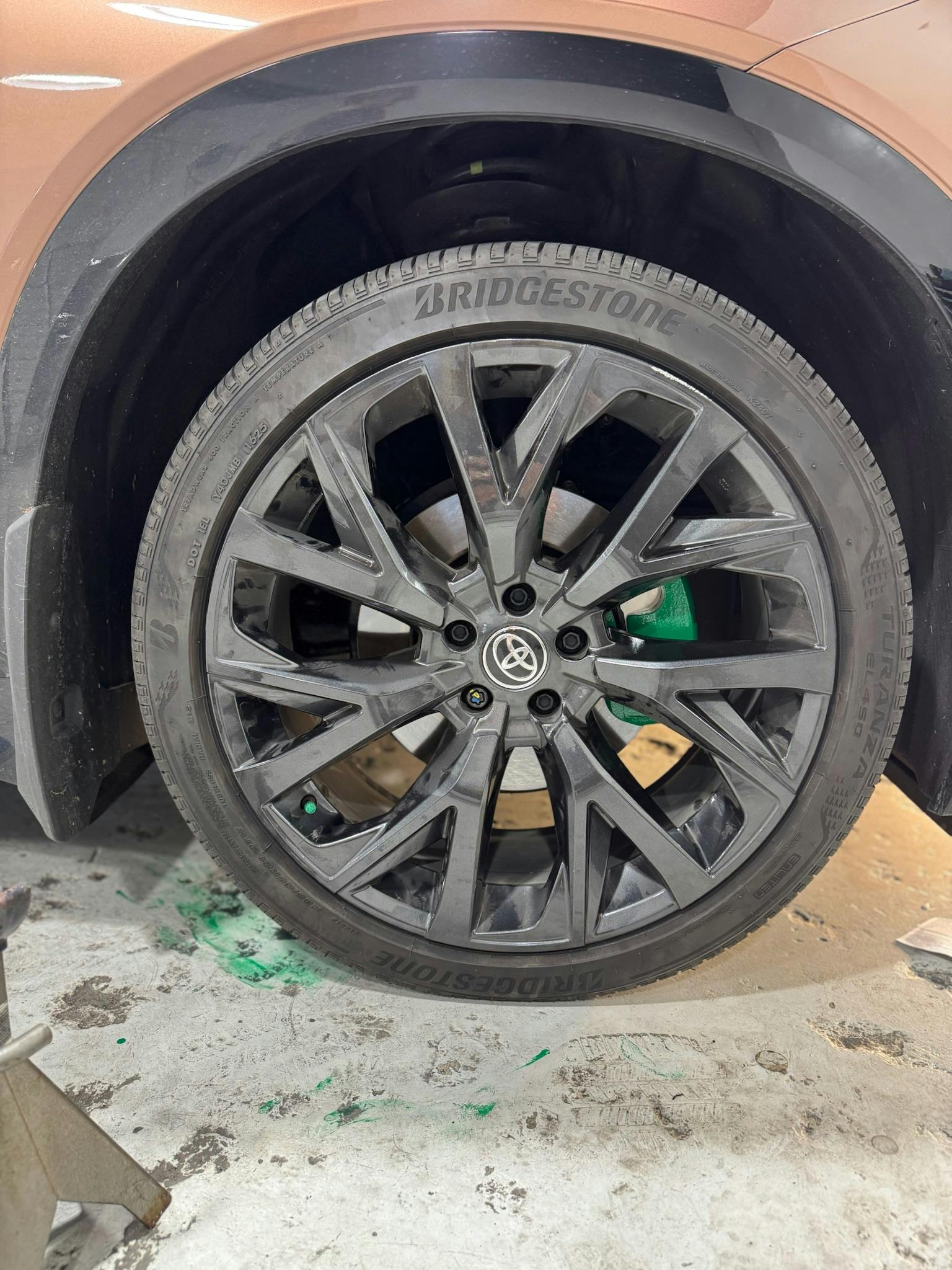 Vehicle brake rotor and caliper before painting with wheel removed in shop