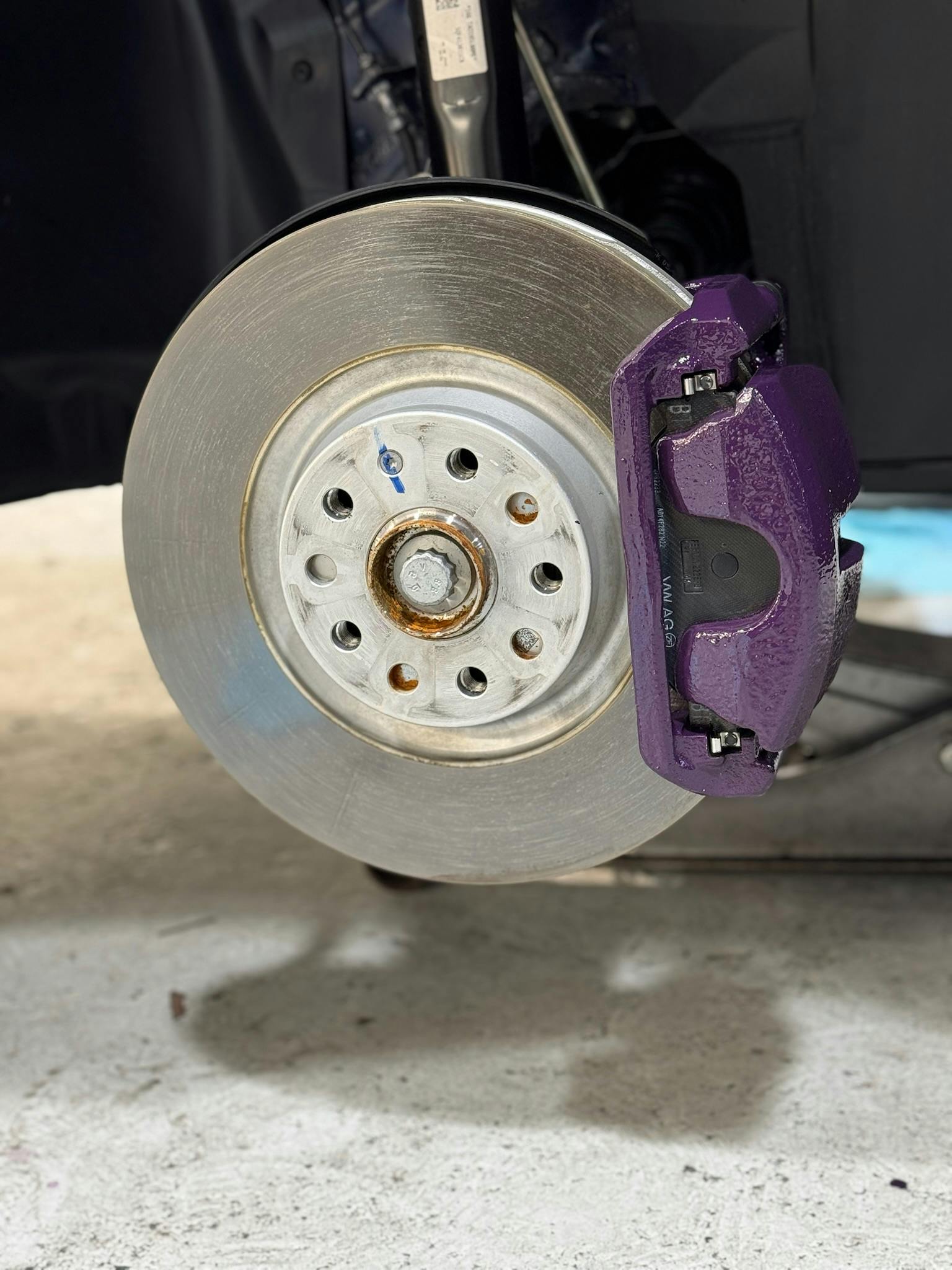 Toyota SUV wheel showing subtle brake caliper upgrade behind dark alloy rim