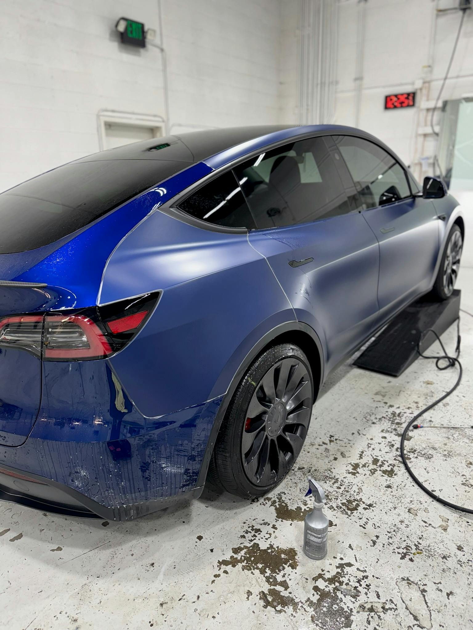 Blue Tesla Model Y receiving paint protection film in our Lynnwood shop