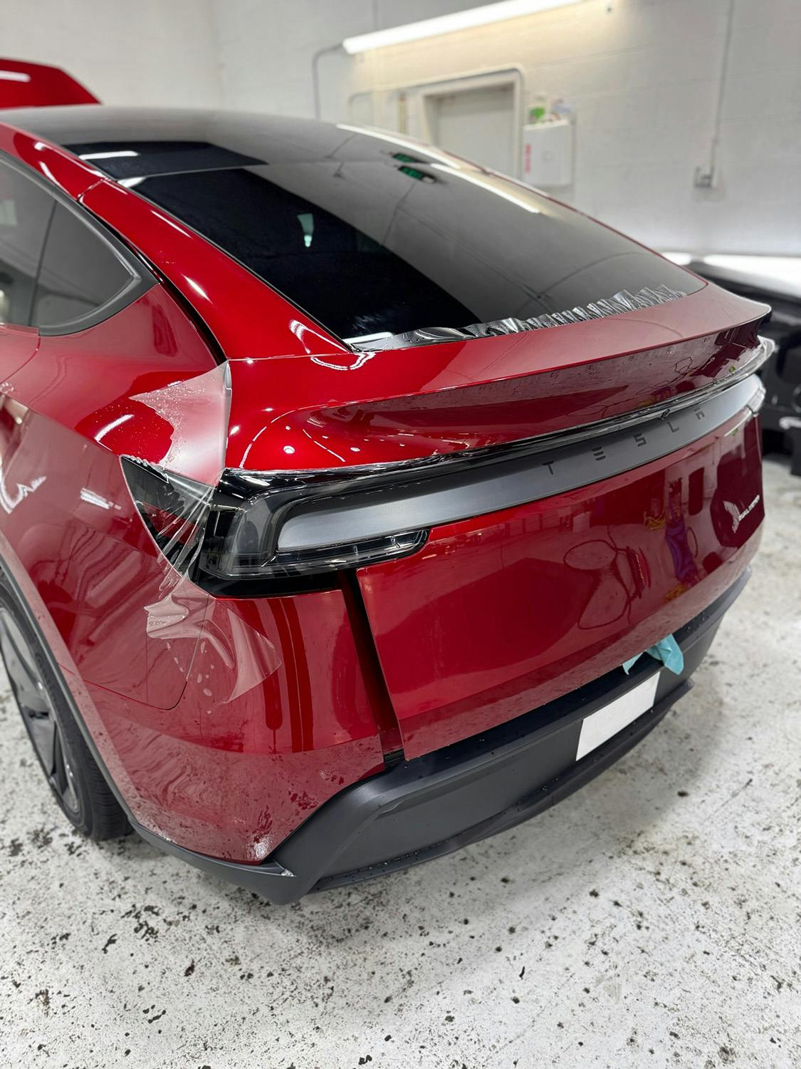 Red Tesla Model Y with PPF applied to the rear panels