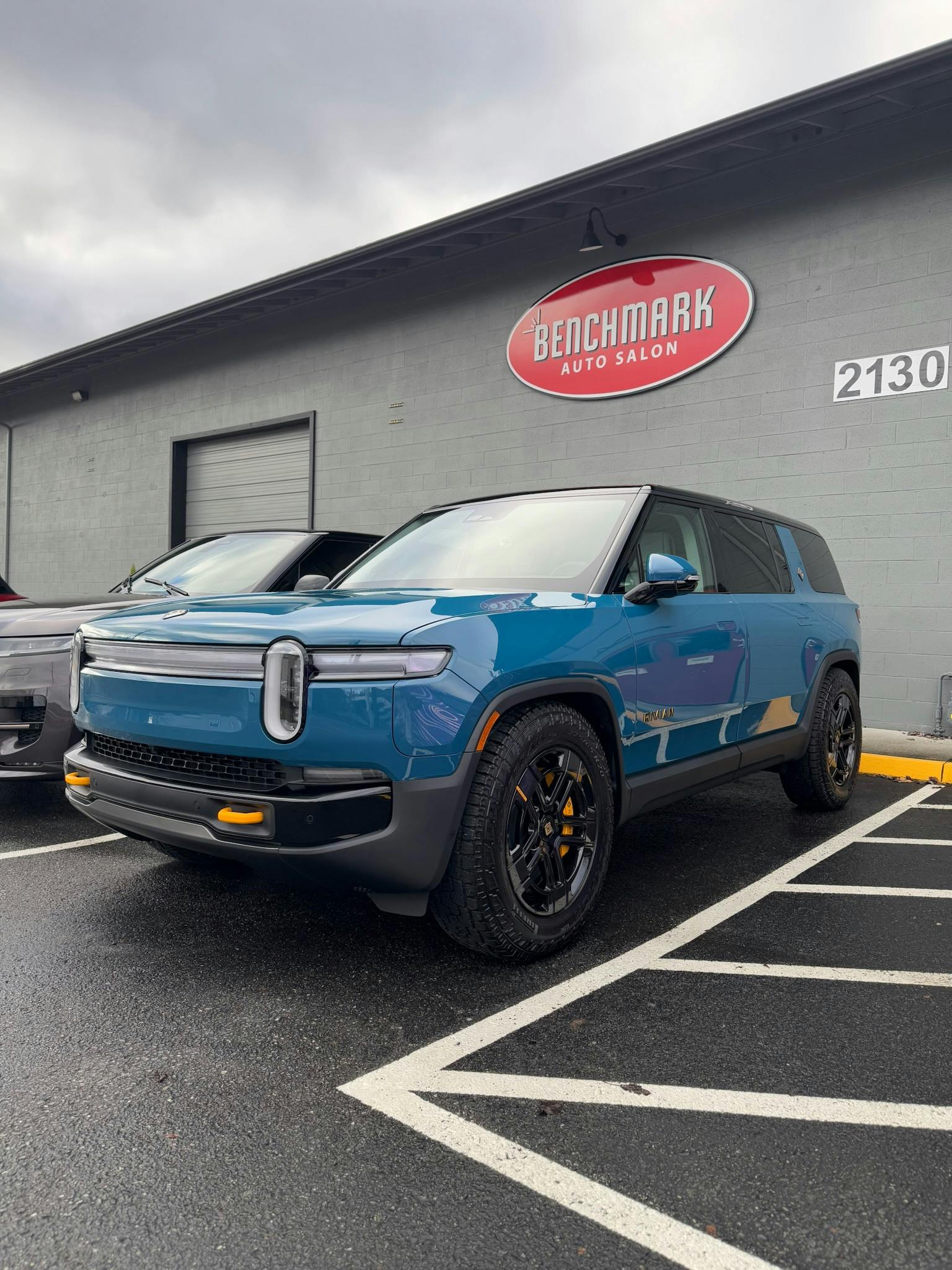 Blue Rivian R1S outside Benchmark Auto Salon in Lynnwood