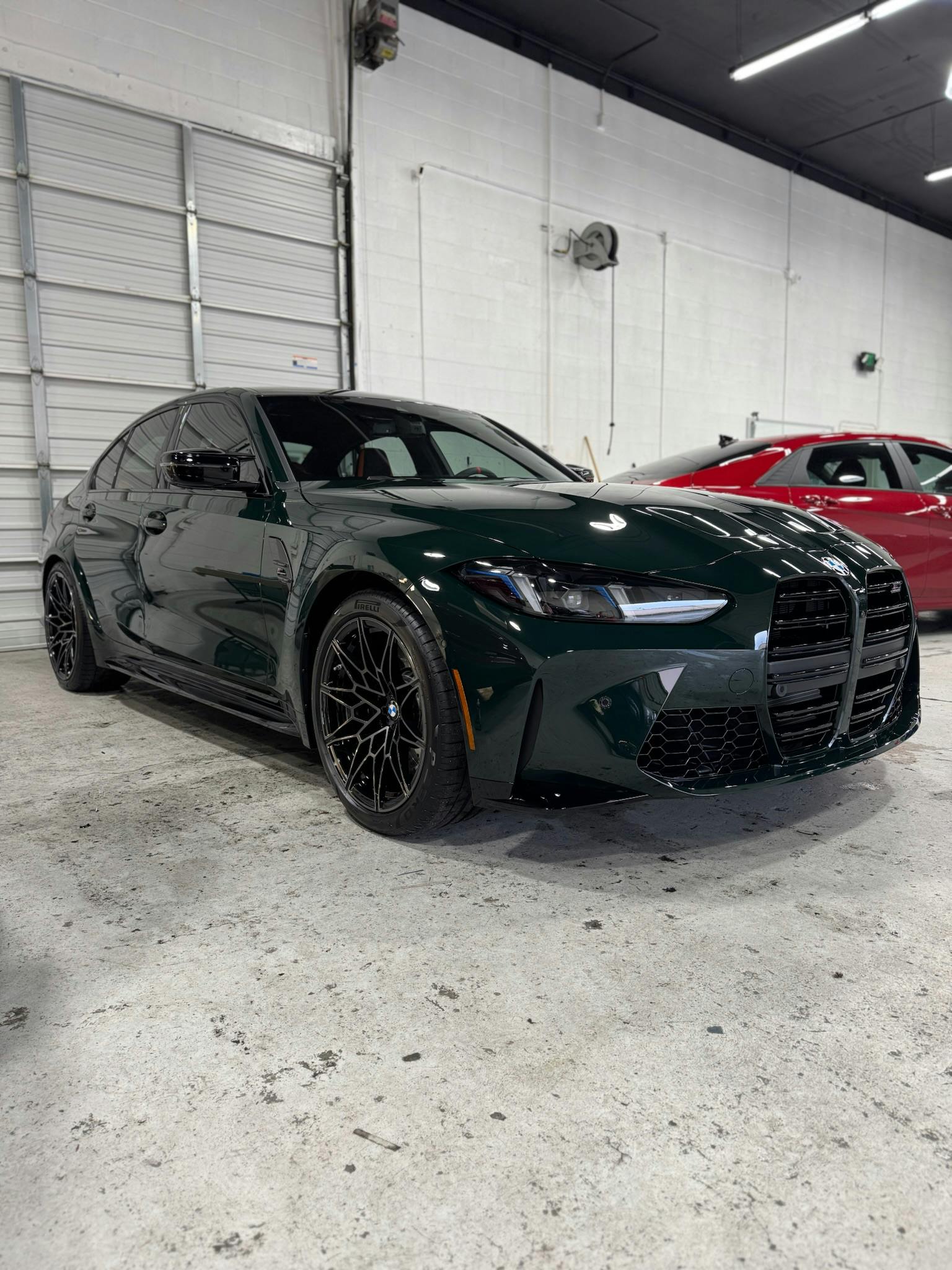 Dark green BMW M3 Competition with XPEL paint protection film at Benchmark Auto Salon