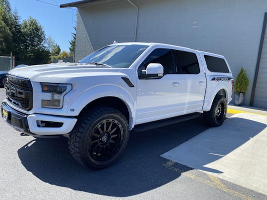 White Ford Raptor leaving the shop