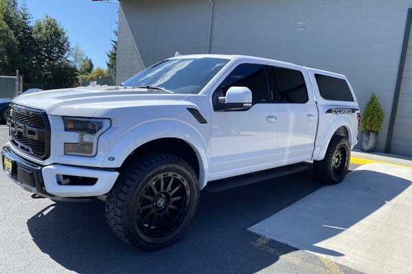 White Ford Raptor leaving the shop