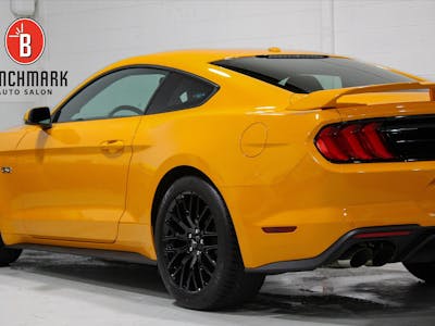 Newly-applied Opti-Coat Pro Plus coating on a yellow Ford Mustang