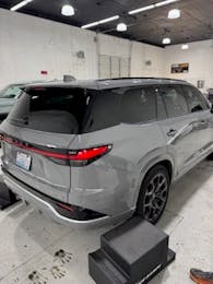 Gray SUV inside the shop after paint protection film installation and detailing