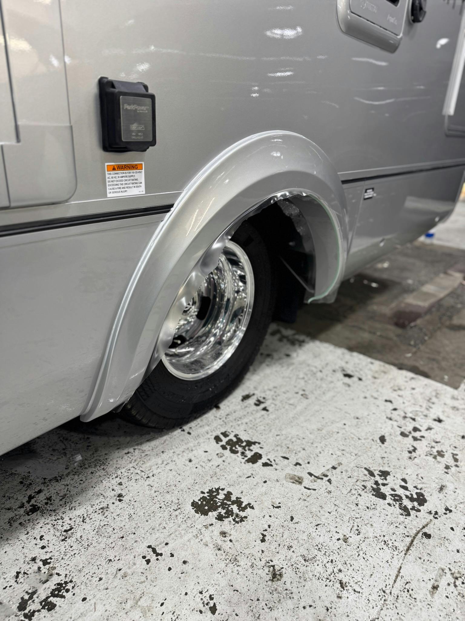 Finished RV wheel arch and polished alloy wheel after PPF install