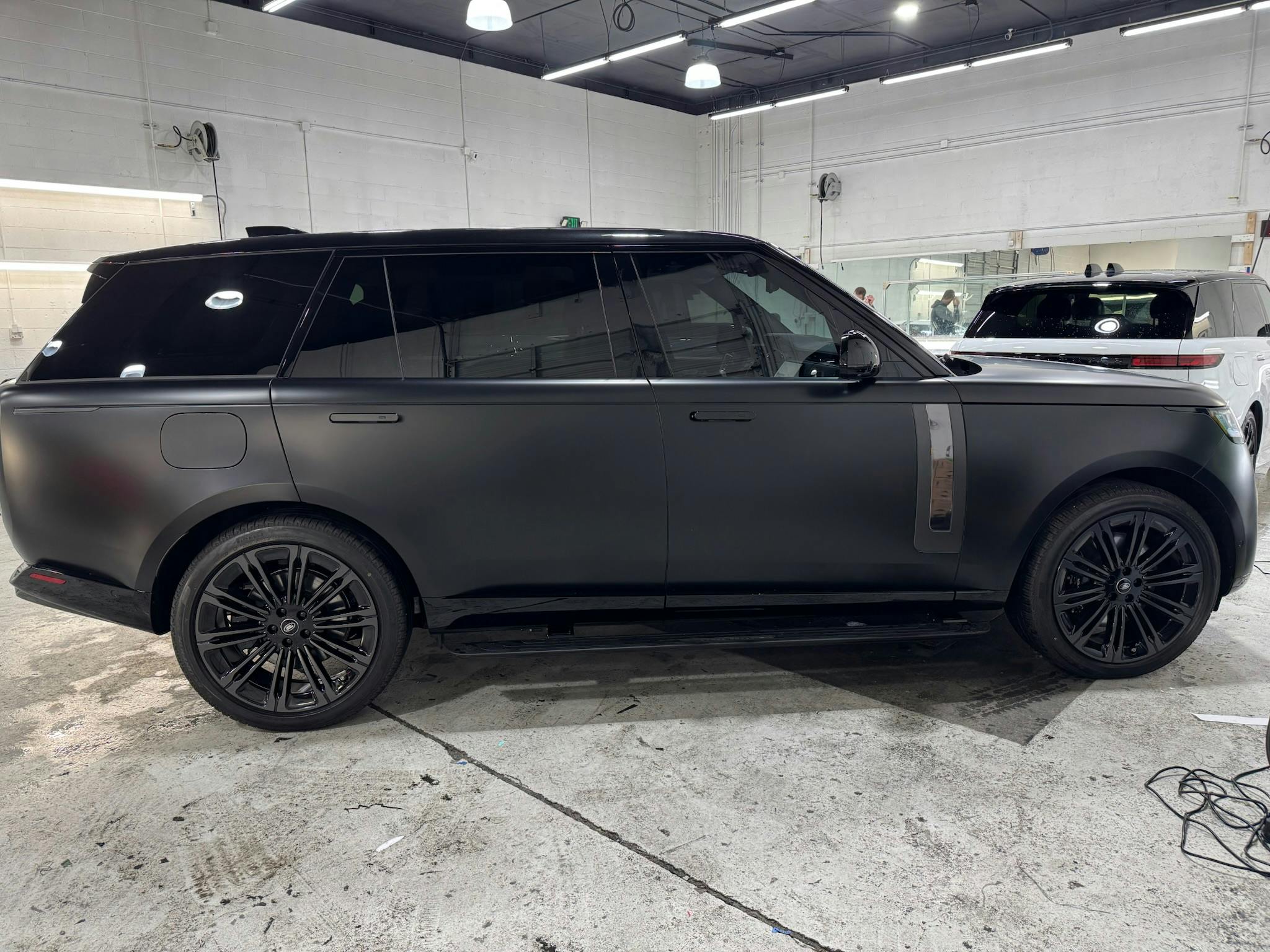 Black Range Rover with XPEL STEALTH satin paint protection film in the install bay
