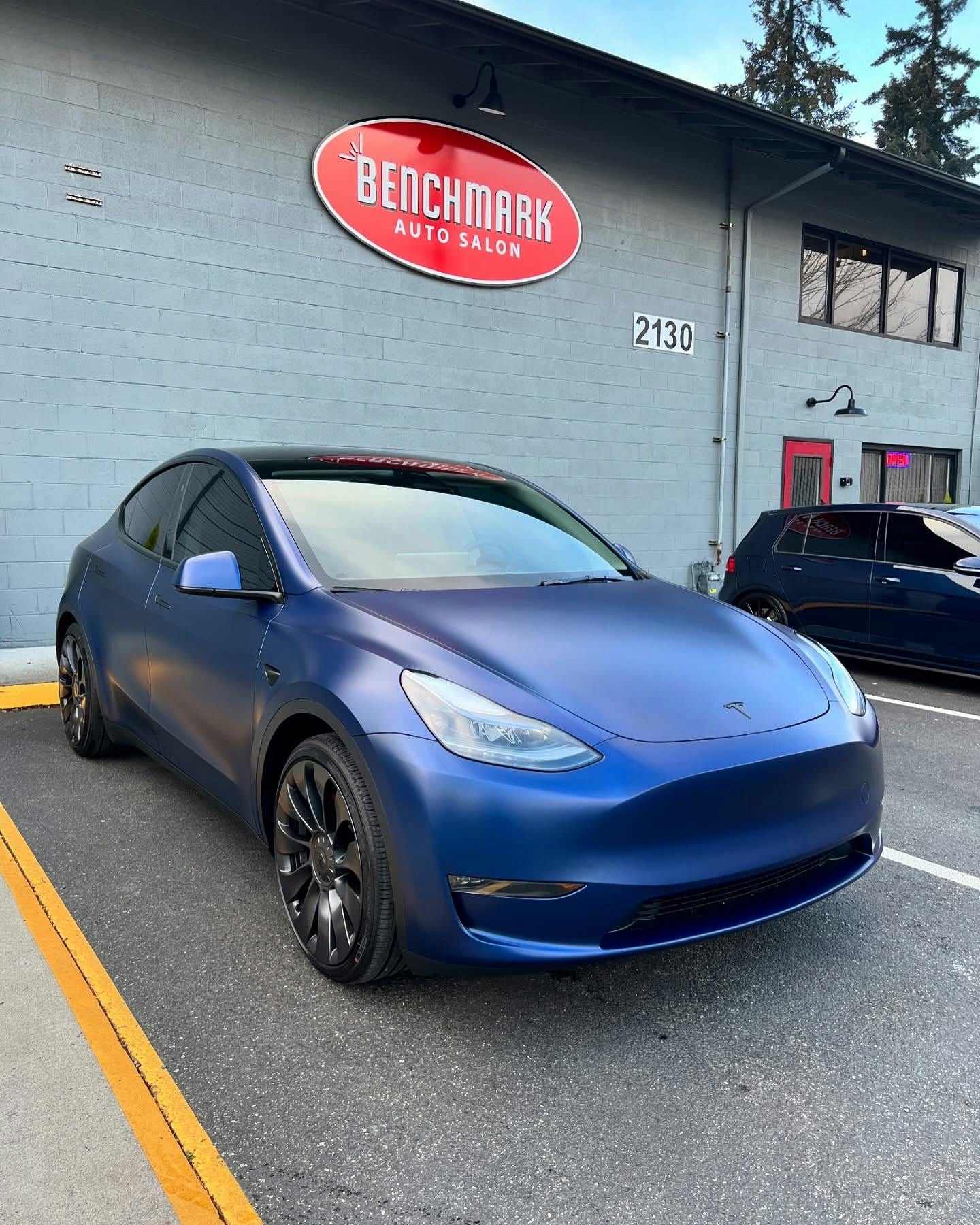 Blue Tesla Model Y with XPEL STEALTH satin PPF outside Benchmark Auto Salon in Lynnwood